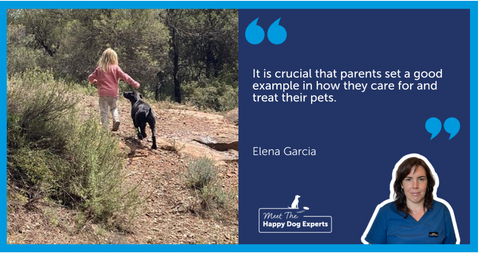 A black dog looking up at a child as they walk.